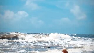 Tik Tok. Beach Voyeur looks on Blonde Teen Enjoying Topless in the Waves.