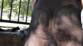 Wife in transparent dress in public park