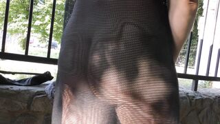 Wife in transparent dress in public park