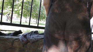 Wife in transparent dress in public park