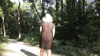 Wife in transparent dress in public park