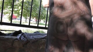 Wife in transparent dress in public park