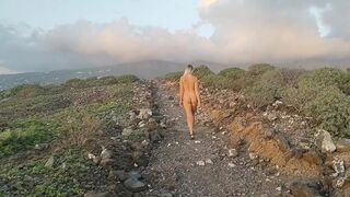 Naked girl in the road to mountains