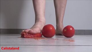 Several tomatoes are crushed under my wonderful bare feet