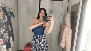 Busty hot brunette is trying dresses in the store