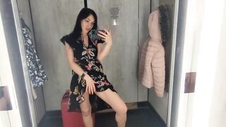 Busty hot brunette is trying dresses in the store