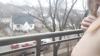 Naked on balcony with fire trucks in background