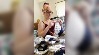 Creature crocheting and singing a tune