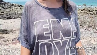 Hot mom in transparent t-shirt on the beach at low tide