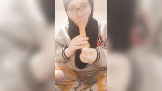 Hijab girl sucks her dildo