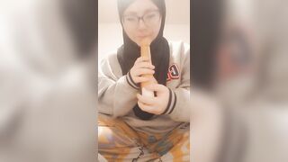 Hijab girl sucks her dildo