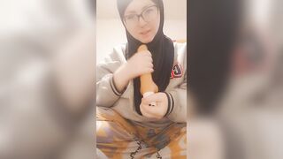 Hijab girl sucks her dildo