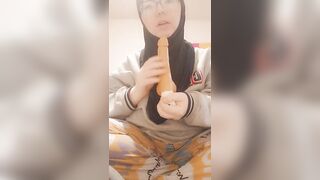 Hijabi girl sucks her dildo