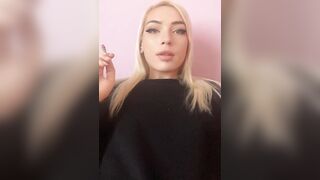 Sexy blonde girl smoke a cigarette