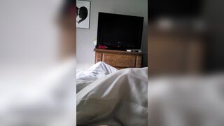 Laying in bed playing with his cock