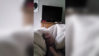 Laying in bed playing with his cock