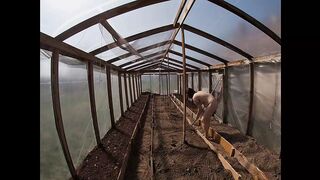 Nude house wife working in the greenhouse