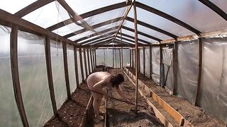 Nude house wife working in the greenhouse