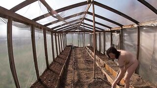 Nude house wife working in the greenhouse