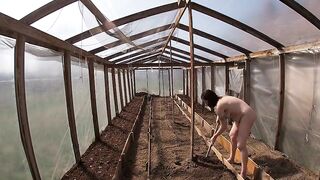 Nude house wife working in the greenhouse